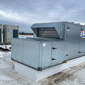 Image of the Tempeff Energy Recovery Ventilators (ERVs) on the rooftop of Derry Green Industrial. Behind the Tempeff units are the Daikin VRF Condensing Units.