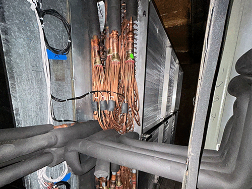 Daikin Emerion VRV coil and piping retrofit inside existing air handling unit.