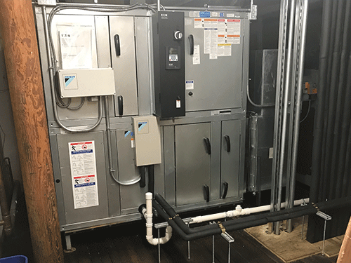 Daikin Vision Air Handling Unit installed indoors with piping and electrical components visible.
