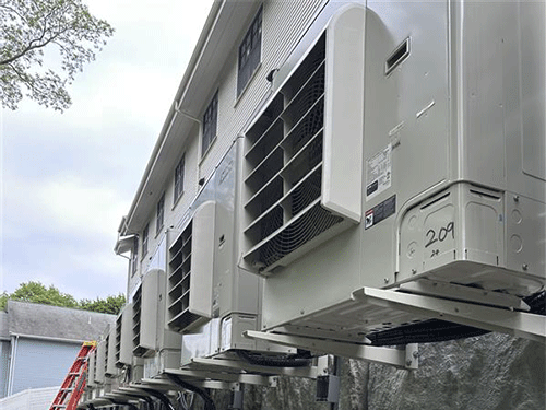 Wall-mounted Daikin VRV Heat Pump units installed on steel supports for ground-level access and service.